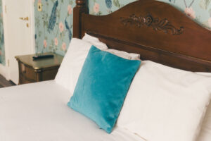 bed with blue and white pillows