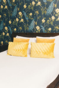 yellow pillows on large bed