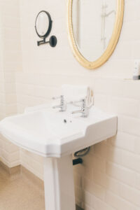 sink with oval mirror above