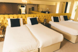 multiple beds in bedroom at rainhill hall