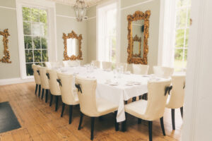 Dining area with table set for guests at rainhill hall