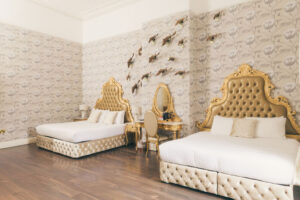 bedroom at rainhill hall with two beds and dresser table